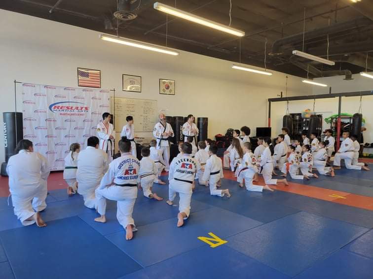 Results Martial Arts class kneeling at attention before training